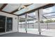 Screened pool area featuring an in-ground pool, white privacy fence, and sliding glass door to the home at 9942 Woodridge Ct, Port Richey, FL 34668