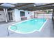 A beautiful screened-in pool with clean water, covered patio, and spacious deck area at 9942 Woodridge Ct, Port Richey, FL 34668