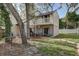 Spacious backyard with patio dining set below balcony with established landscaping and fencing at 10910 Winter Oak Pl, Tampa, FL 33618
