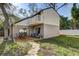 View of the backyard featuring an outdoor seating area, sliding glass doors, and a second-story balcony at 10910 Winter Oak Pl, Tampa, FL 33618