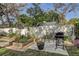 Backyard featuring raised garden beds, patio, and outdoor seating area for entertaining at 10910 Winter Oak Pl, Tampa, FL 33618
