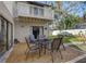 Outdoor dining set situated on gravel in a landscaped backyard, offering a relaxing entertainment space at 10910 Winter Oak Pl, Tampa, FL 33618