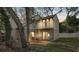 Cozy backyard patio with outdoor seating, accessed by sliding glass doors and featuring a second-story balcony at 10910 Winter Oak Pl, Tampa, FL 33618