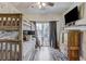 Bedroom with hardwood floors, bunk beds, wood accent wall, and a sliding glass door at 10910 Winter Oak Pl, Tampa, FL 33618