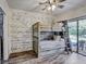 Cozy bedroom features a bunk bed, wood accent wall, and sliding glass doors to the outside at 10910 Winter Oak Pl, Tampa, FL 33618