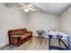 Bright bonus room with a ceiling fan, featuring an air hockey table and keyboard at 10910 Winter Oak Pl, Tampa, FL 33618