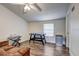 Bright bonus room featuring an air hockey table, keyboard, and mini-fridge at 10910 Winter Oak Pl, Tampa, FL 33618
