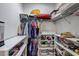Walk-in closet with shelving, clothes rack, and many personal items at 10910 Winter Oak Pl, Tampa, FL 33618