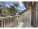 A beautiful deck off the Primary bedroom with white railings and a sliding glass door at 10910 Winter Oak Pl, Tampa, FL 33618