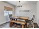 Dining room with wood table, a bench, and white accent wall at 10910 Winter Oak Pl, Tampa, FL 33618