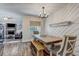 Dining room with wood table, a bench, and direct access to the living room at 10910 Winter Oak Pl, Tampa, FL 33618