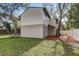 Exterior view of the house showcasing the lawn and the trees around the property at 10910 Winter Oak Pl, Tampa, FL 33618
