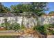 Inviting garden with lush flower beds and an arched trellis creates a peaceful outdoor space at 10910 Winter Oak Pl, Tampa, FL 33618