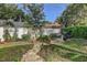 A charming garden with raised beds, a white fence, and a lush green lawn at 10910 Winter Oak Pl, Tampa, FL 33618