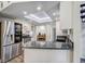 Charming kitchen featuring granite countertops, white cabinetry, stainless steel appliances and plenty of natural light at 10910 Winter Oak Pl, Tampa, FL 33618