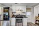 Updated kitchen features stainless steel appliances and white cabinets at 10910 Winter Oak Pl, Tampa, FL 33618