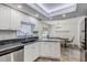 Bright kitchen with stainless steel appliances, granite countertops, and dining area at 10910 Winter Oak Pl, Tampa, FL 33618