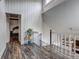 Hardwood landing featuring a plant, access to the second floor, and natural light at 10910 Winter Oak Pl, Tampa, FL 33618