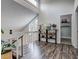 Landing featuring hardwood floors, a wooden shelving unit, and natural light at 10910 Winter Oak Pl, Tampa, FL 33618