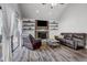 Bright living room with vaulted ceilings, hardwood floors, a cozy fireplace, comfortable leather furniture, and ample natural light at 10910 Winter Oak Pl, Tampa, FL 33618