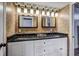Elegant main bathroom boasts double sinks with granite counters and modern fixtures at 10910 Winter Oak Pl, Tampa, FL 33618