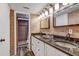 Elegant main bathroom boasts double sinks with granite counters and a beautiful tiled shower at 10910 Winter Oak Pl, Tampa, FL 33618