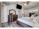 Main bedroom features a luxury dresser, TV, wooden ceiling, and bright natural lighting at 10910 Winter Oak Pl, Tampa, FL 33618