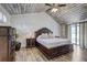 Spacious main bedroom featuring a wooden ceiling, luxury bed, and exterior access at 10910 Winter Oak Pl, Tampa, FL 33618