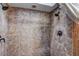 Tiled shower features dual shower heads and neutral colored stone-look tile at 10910 Winter Oak Pl, Tampa, FL 33618