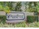 Community signage for Carrollwood South surrounded by tropical plants and manicured landscape at 10910 Winter Oak Pl, Tampa, FL 33618