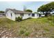 Exterior view of the home featuring an enclosed lanai in the backyard at 11224 Yewtree Ave, Port Richey, FL 34668