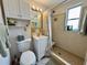 Well-lit bathroom with a walk-in shower and white vanity at 11224 Yewtree Ave, Port Richey, FL 34668
