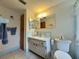 Well-maintained bathroom featuring a vanity with storage, toilet, and tiled floor at 11224 Yewtree Ave, Port Richey, FL 34668