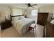 Comfortable bedroom with a plush bed, ceiling fan, and ample natural light from the windows at 11224 Yewtree Ave, Port Richey, FL 34668