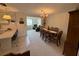 Open dining area featuring a chandelier, adjacent to the kitchen and living room for easy entertaining at 11224 Yewtree Ave, Port Richey, FL 34668