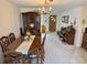 Charming dining room featuring hardwood table, crystal chandelier, and elegant china cabinet at 11224 Yewtree Ave, Port Richey, FL 34668