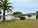 Charming single-story home featuring an attached garage, white exterior, and mature tree at 11224 Yewtree Ave, Port Richey, FL 34668