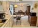 Open kitchen view leading to a dining area with hardwood table and chairs at 11224 Yewtree Ave, Port Richey, FL 34668
