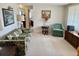 Comfortable living room featuring a floral sofa, artwork, and a cozy green armchair at 11224 Yewtree Ave, Port Richey, FL 34668