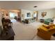 Spacious living room showcasing an open floor plan, neutral carpet, and classic furnishings at 11224 Yewtree Ave, Port Richey, FL 34668