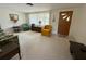 Cozy living room featuring neutral carpeting, comfortable seating, and plenty of natural light at 11224 Yewtree Ave, Port Richey, FL 34668