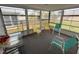 Enclosed sunroom with sliding glass windows and casual seating arrangement at 11224 Yewtree Ave, Port Richey, FL 34668