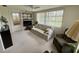 Relaxing sunroom featuring ample windows, comfortable seating, and plenty of natural light at 11224 Yewtree Ave, Port Richey, FL 34668