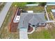 Aerial view of home with well-maintained lawn, playset, and a screened lanai at 1219 Aladdin Rd, Spring Hill, FL 34609
