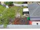 Aerial view of home showing backyard with screened lanai, playset, shed, and fenced perimeter at 1219 Aladdin Rd, Spring Hill, FL 34609