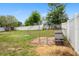 Fenced backyard with a chicken coop, shed, and some trees at 1219 Aladdin Rd, Spring Hill, FL 34609