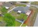 Aerial view of the backyard showing a covered patio, a playground, white fencing, and grassy area at 1219 Aladdin Rd, Spring Hill, FL 34609