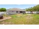 Spacious backyard featuring a screened porch, chicken coop, playset, and a white fence at 1219 Aladdin Rd, Spring Hill, FL 34609
