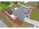 Aerial view showcasing the backyard with a patio, fire pit, fresh mulch, and white fencing at 1219 Aladdin Rd, Spring Hill, FL 34609