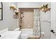 Stylish bathroom with bathtub, shower curtain, storage and a neutral color palette at 1219 Aladdin Rd, Spring Hill, FL 34609